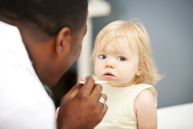 doctor looking into a toddler's eyes